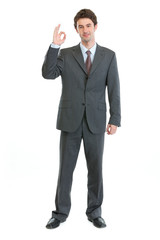 Full length portrait of businessman showing ok gesture