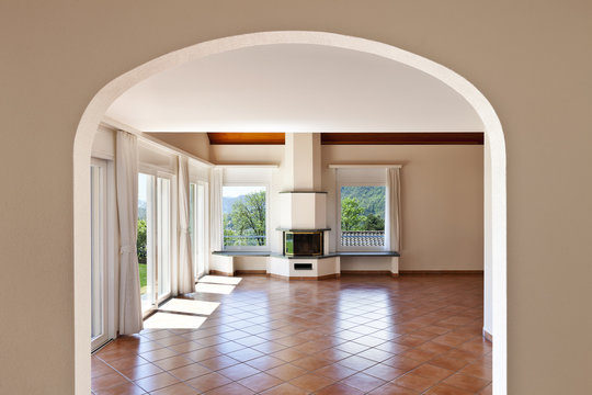 home, arched window, view of room with fireplace