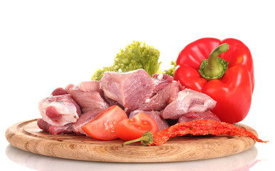 Pieces of raw meat and vegetables