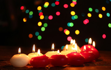 Beautiful candles on wooden table on bright background