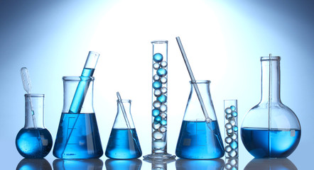 Test-tubes with blue liquid on blue background