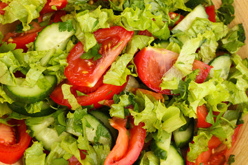 Fresh salad with tomatoes and cucumbers close-up
