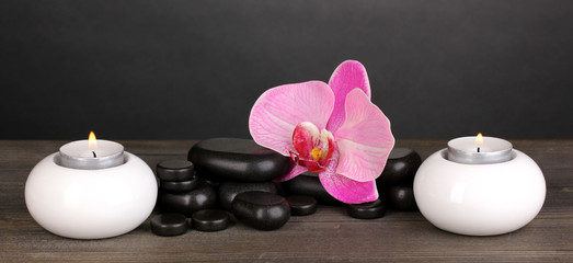 Fototapeta na wymiar Spa stones with orchid flower and candles