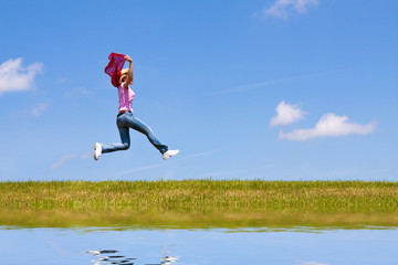 Woman jumps on the meadow