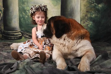 Adorable Child and Her Saint Bernard Puppy Dog