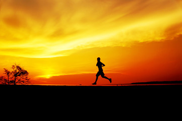 silhouette man jogging on sunset
