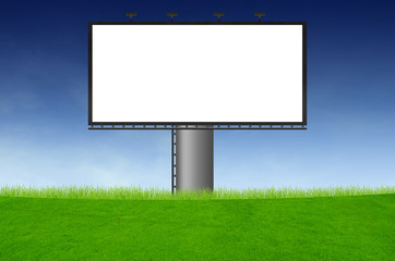 Blank billboard on green field and the blue sky in background
