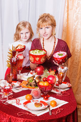 mother with the daughter at a Christmas table