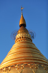 Fototapeta premium Stupa at Shwezigon pagoda, golden in sunset in Bagan, Myanmar