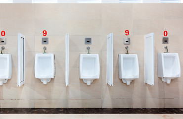modern restroom interior with urinal row