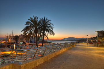 Marbella harbor and cliff  at sunset