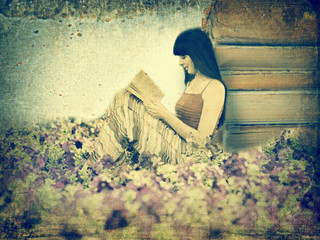 Woman reading book on the meadow