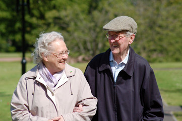 Happy senior couple strolling in the park