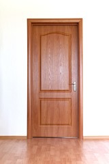 Brown door in white wall