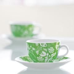 two cups of tea on a glass table