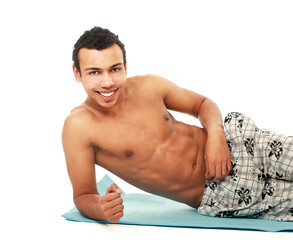 Obraz premium A young muscular man training, isolated on white