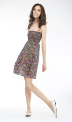 Pretty brunette girl in fashion dress on white background