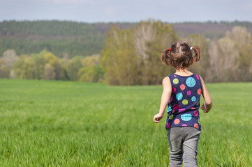 Fototapeta premium Active happy child having fun on green field