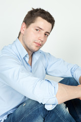 portrait of a young man in blue jeans and shirt