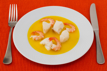fish with shrimps in sauce on the plate