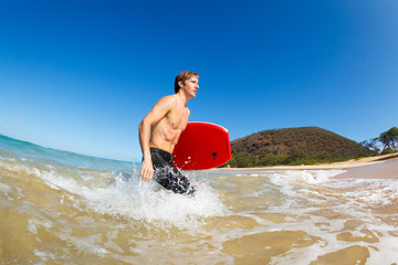 Young Man with Boogie Board at the Beach