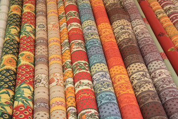 Rolls of Provencal textile on a market stall