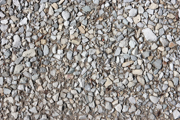 Background with crushed stone. Mountain road.