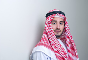 Portrait of a handsome young arabian business man leaning