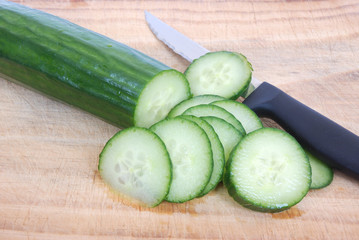 Cutting English cucumber slices