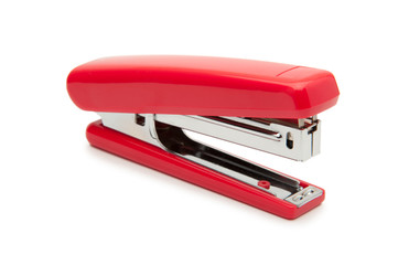Red stapler on a white background. - obrazy, fototapety, plakaty