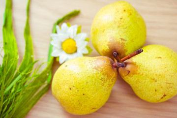 pears on dinner table with daisy
