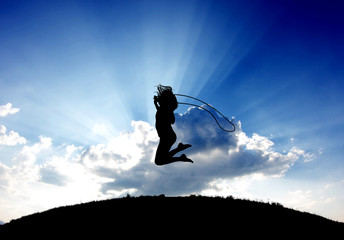Silhouette of young girl jumping with a jumprope - 41739441