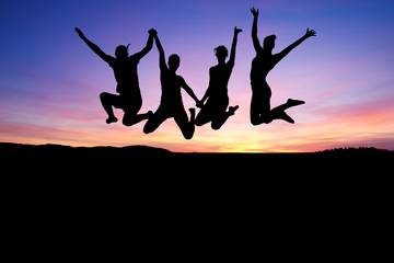 silhouette of teenagers jumping in sunset for fun - 41739485
