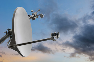 satellite rooftop dish with wind meter and dramatic cloudy sky © A2LE