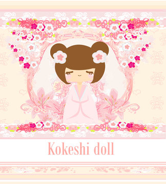 Kokeshi doll on the pink background