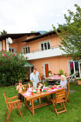 Family having a barbecue in the garden, eating