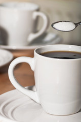 Cup of coffee and a spoon of suger