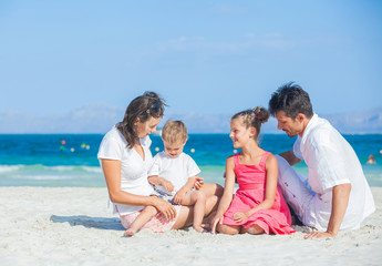 Family of four on tropical beach