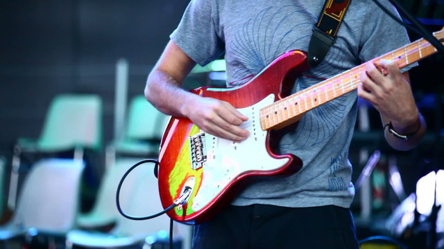 A guitarist in live action at a concert