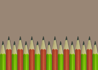 green and orange pencil on brown background 2