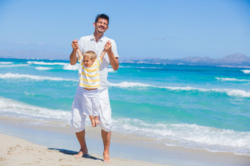 Father and son having fun on beach