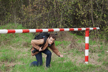 A young man passes under the barrier