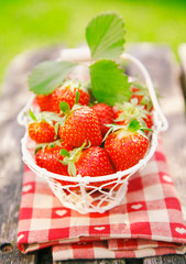 Fresh strawberries in small white basket