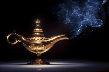 Magic Aladdin's Genie lamp on black with smoke - obrazy, fototapety, plakaty