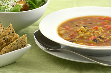 Black bean and corn soup with salad and crispy crackers
