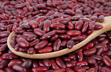 Red beans on wooden spoon.