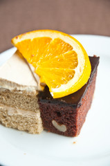 Chocolate and vanilla cake  with slice of orance
