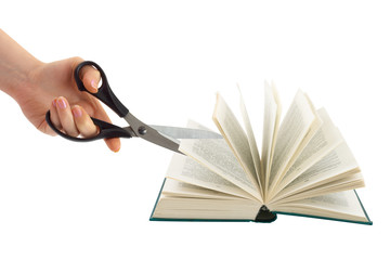 Hand with scissors cutting book