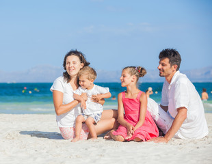 Family of four on tropical beach