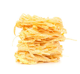 Italian pasta tagliatelle nest isolated on white background